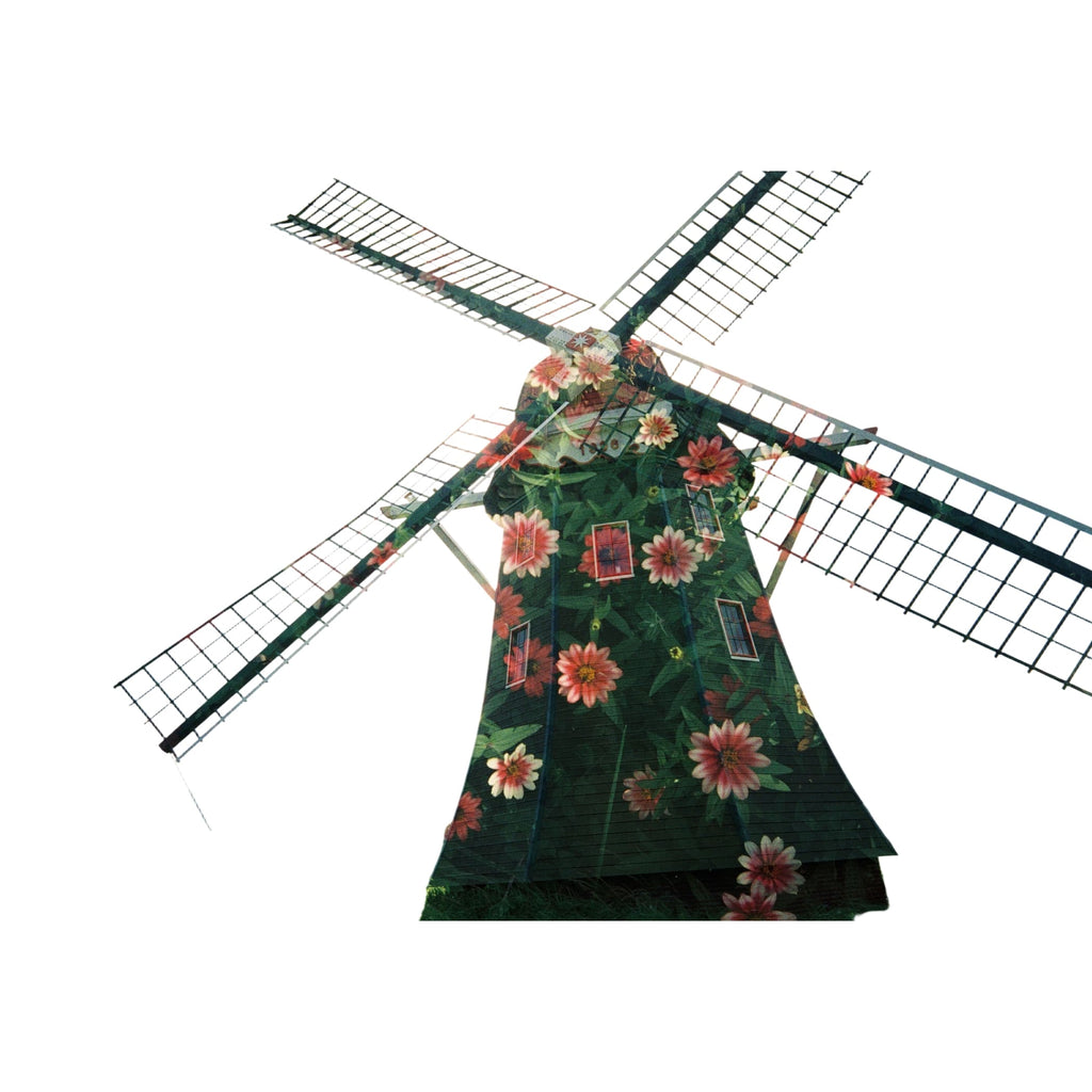 A green windmill adorned with vibrant pink and orange flowers, featuring a painted design on its wooden structure.