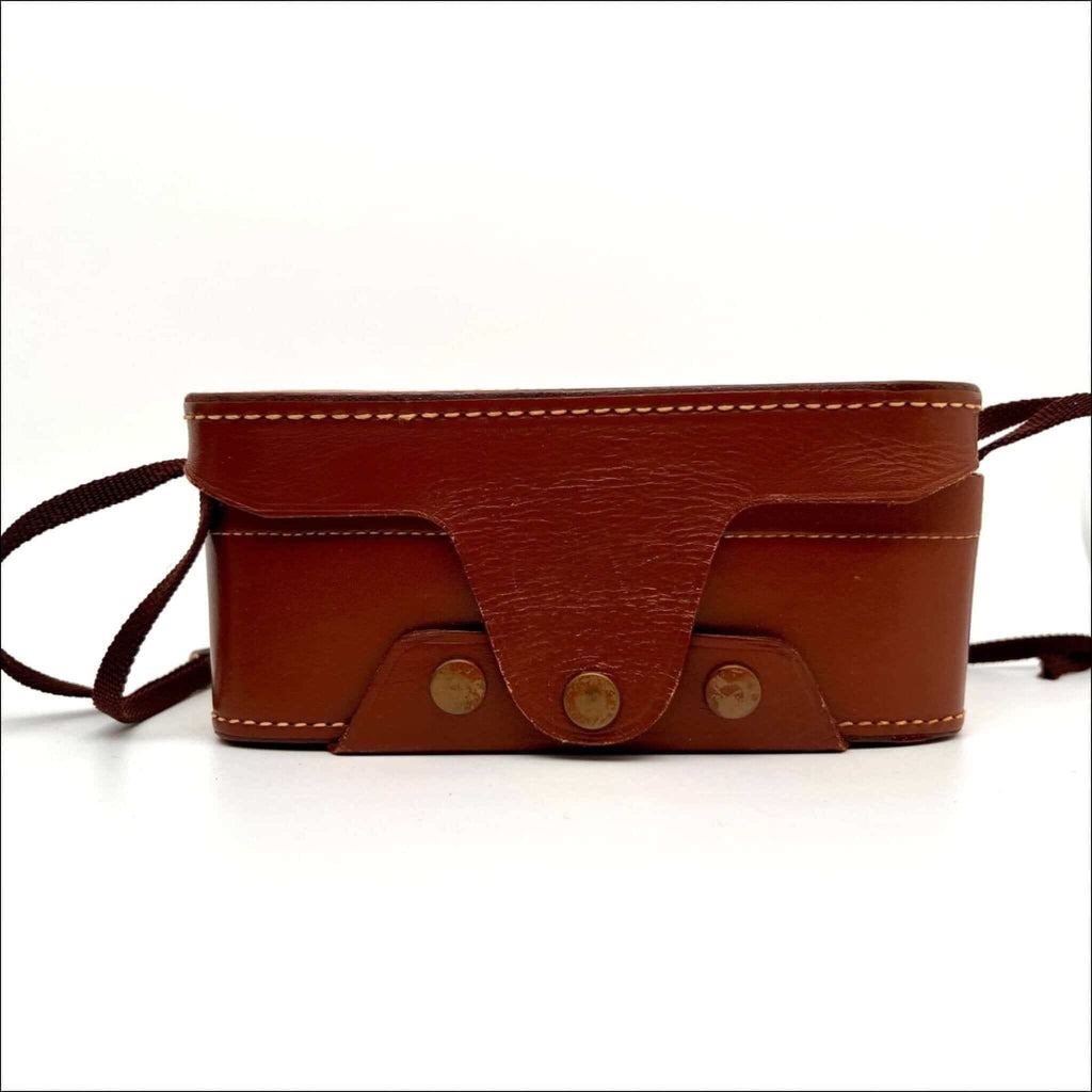 Brown leather camera case with tan stitching and brass-toned metal fasteners.