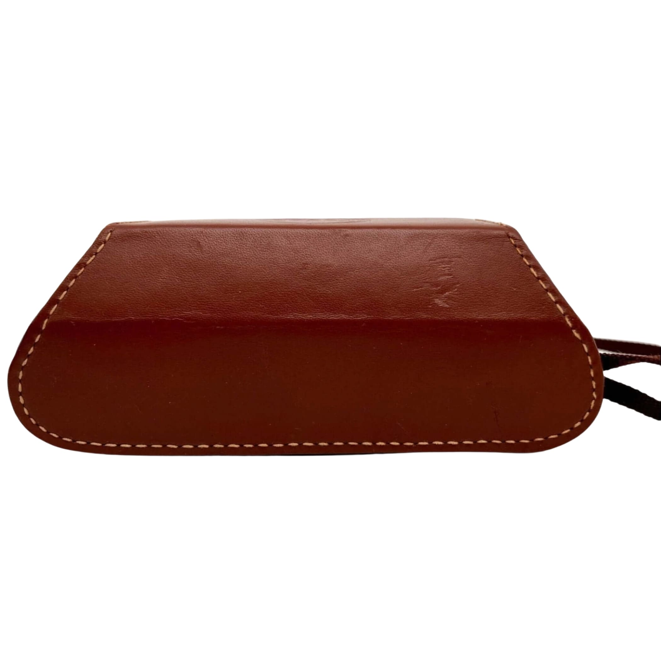 Brown leather camera case with contrasting white stitching and a black strap.