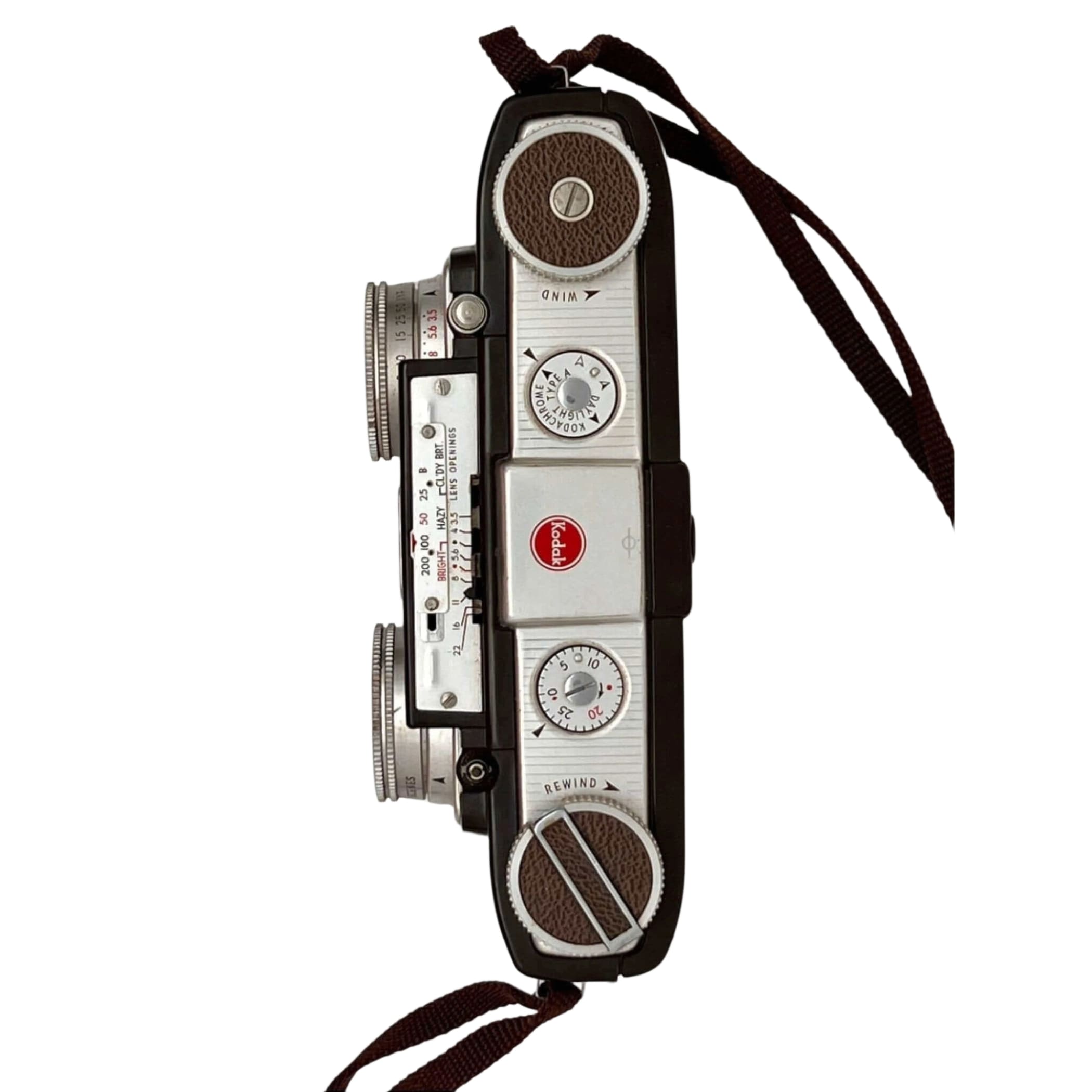 Vintage kodak brownie camera with a silver and black body, brown leather accents on the dials, and classic film rewind and wind knobs.