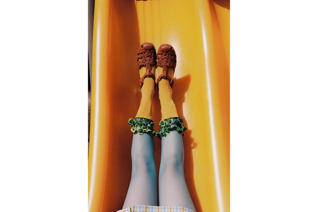 Brown crocheted sandals with a textured, intricate pattern.