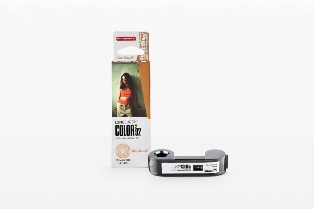 Lomography LomoChrome Color ’92 Sun-kissed ISO 400 film packaging with camera, showcasing nostalgic retro vibes.