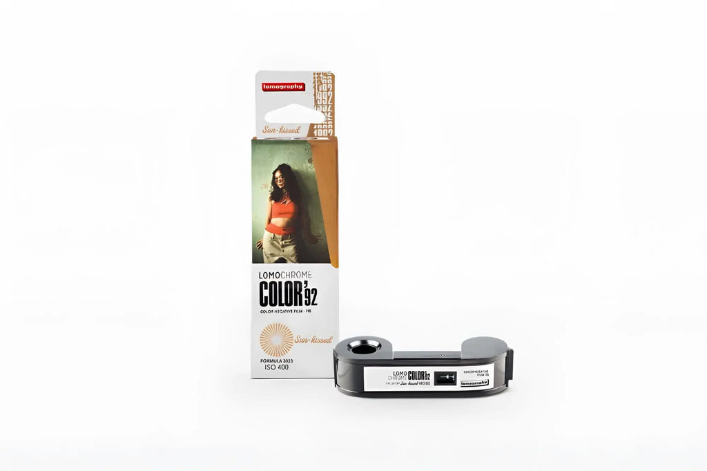 Lomochrome color 32 color negative film in a sleek black and silver cartridge with a minimalist design, packaged alongside its branded retail box.