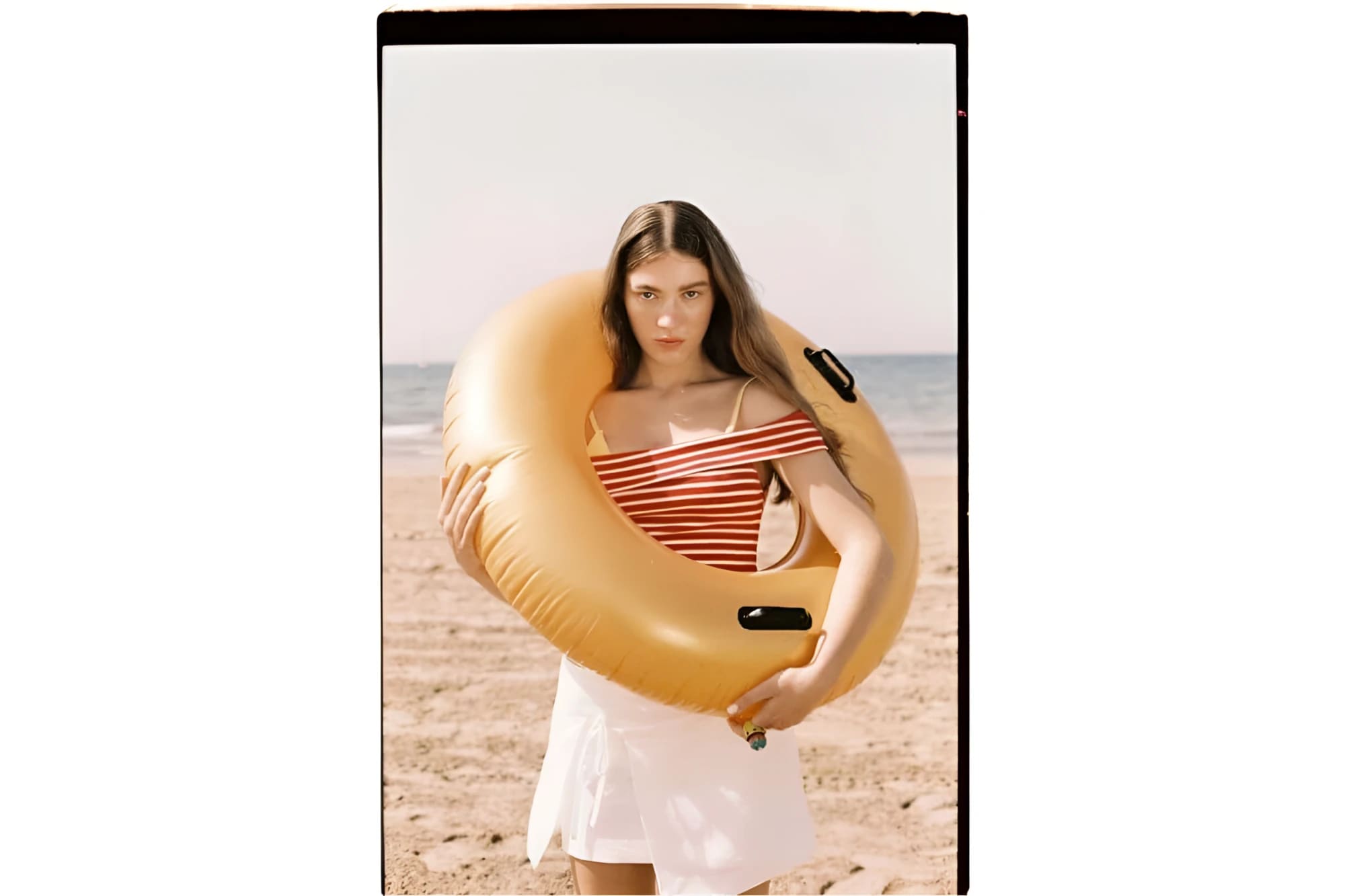 Yellow inflatable swim ring with black handles