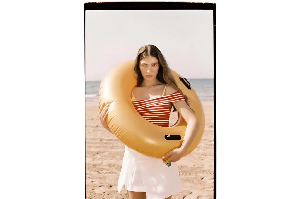 Yellow inflatable swim ring with black handles