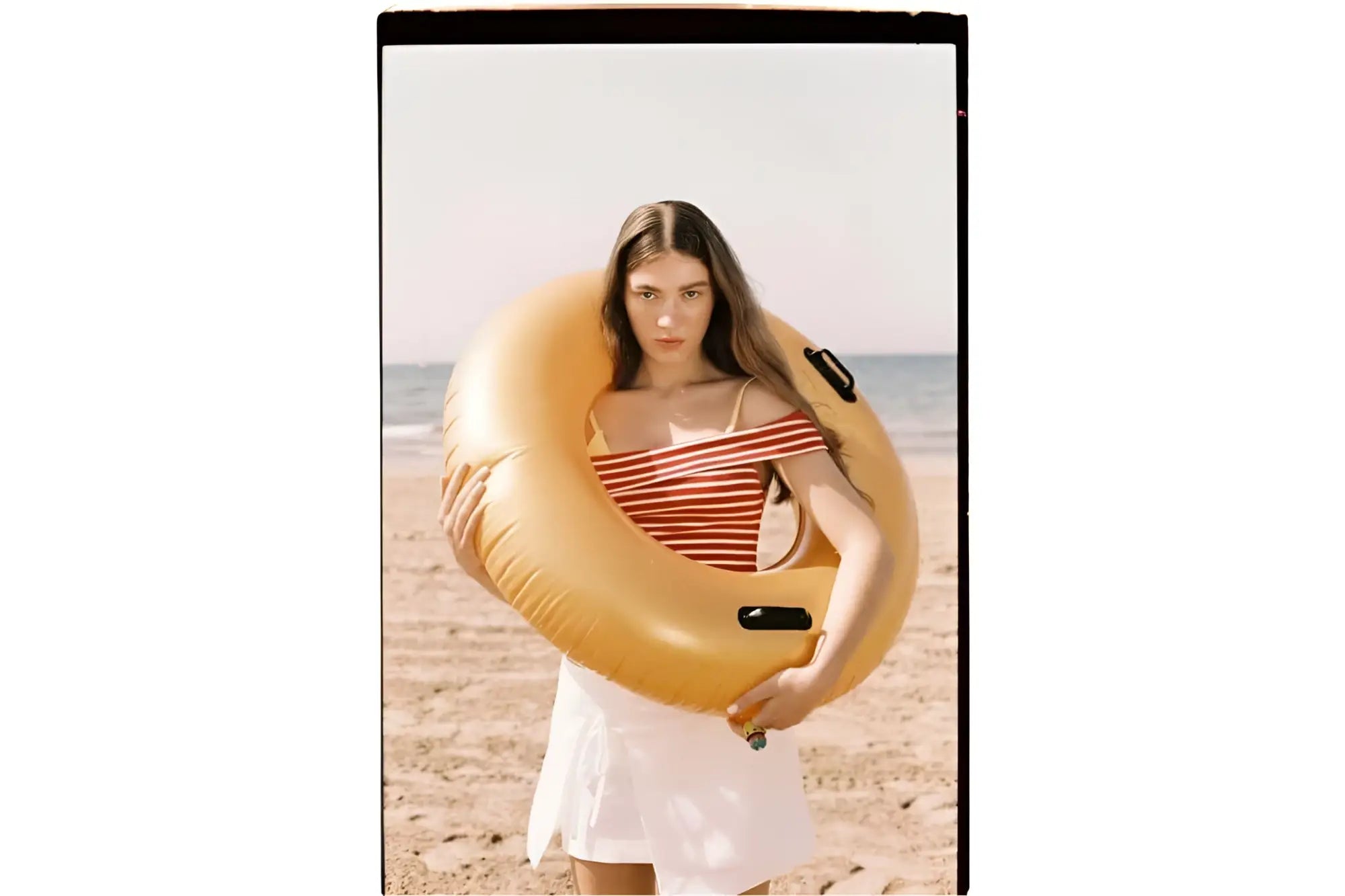 Yellow inflatable swim ring with black handles