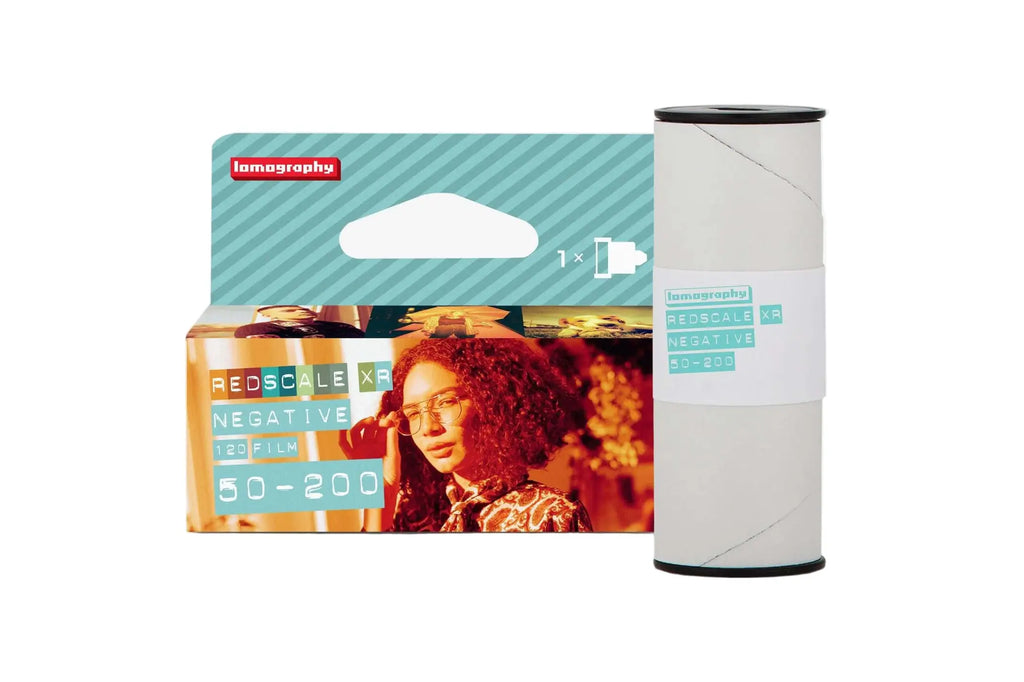 Lomography redscale xr 120 film roll in a teal and white package with a woman’s portrait on the front.