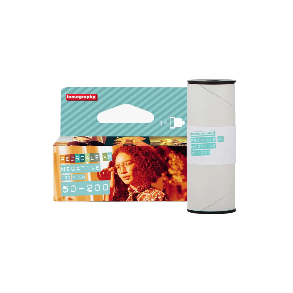 Lomography redscale xr 120 film roll in a teal and white package with a woman’s portrait on the front.