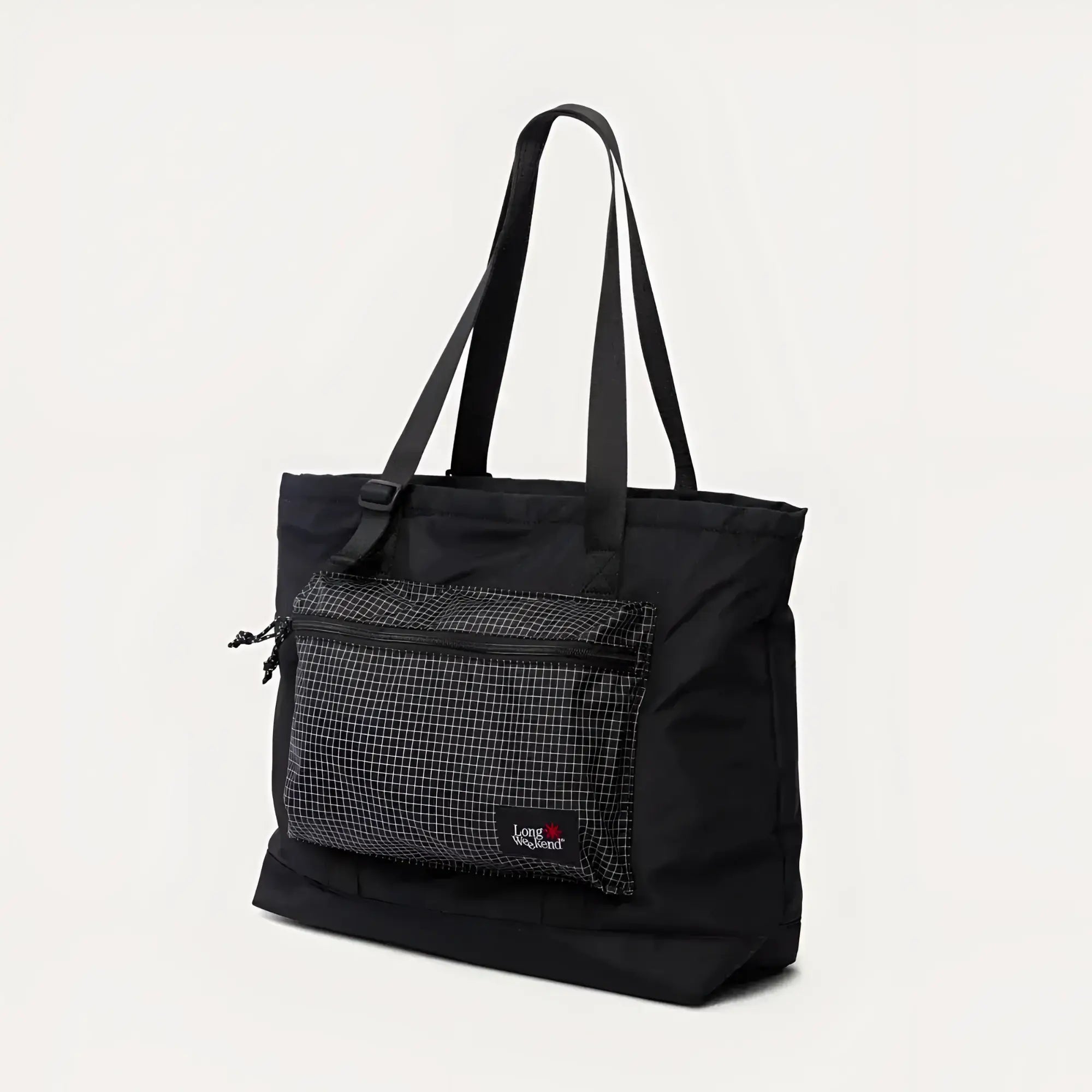 Black tote bag with a grid-patterned front pocket and adjustable shoulder strap.