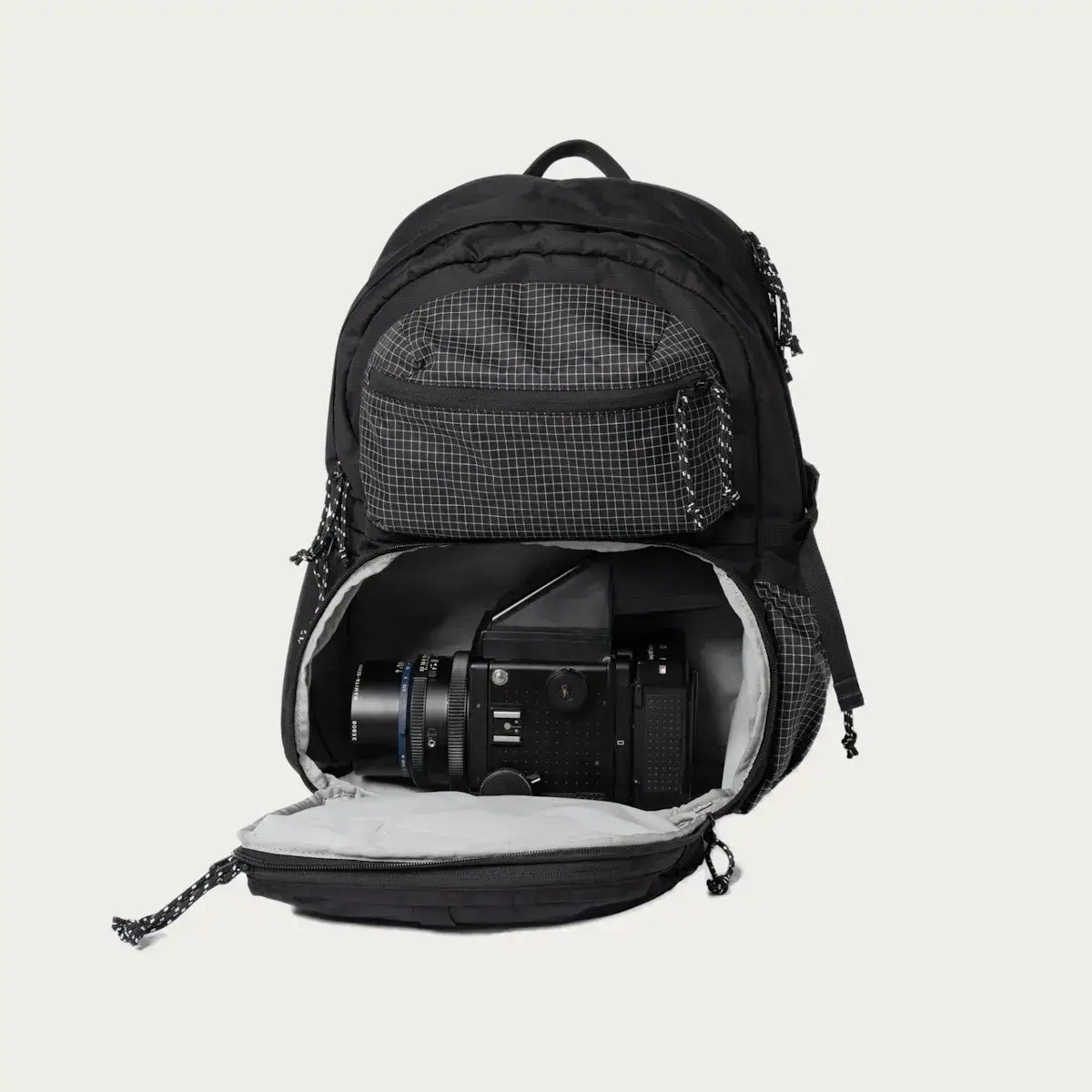 Open black Morro Convertible Backpack showing padded camera compartment for photography gear.