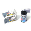 A roll of black and white film labeled ’shd100’’ with a silver and blue design, housed in its original packaging.