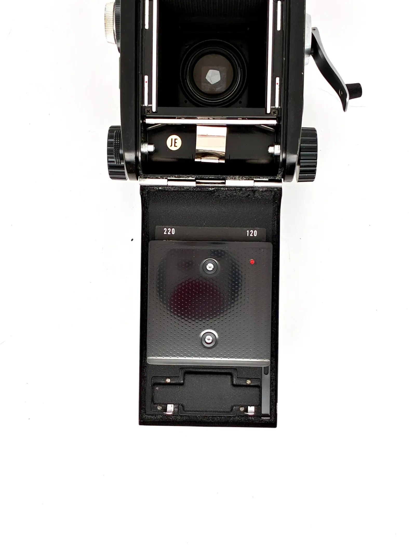 Vintage camera with open back on a white background