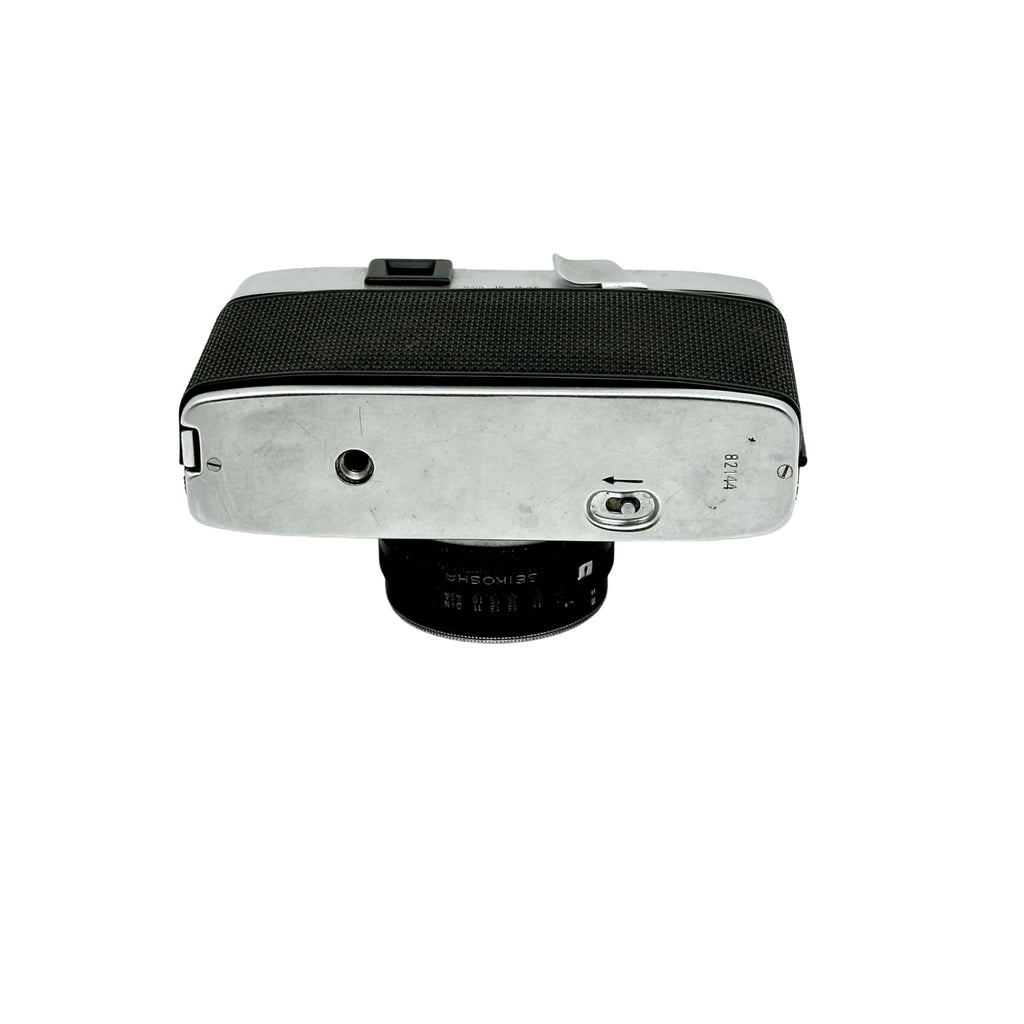 Silver-bodied rangefinder camera with black textured grip and a 35mm lens.