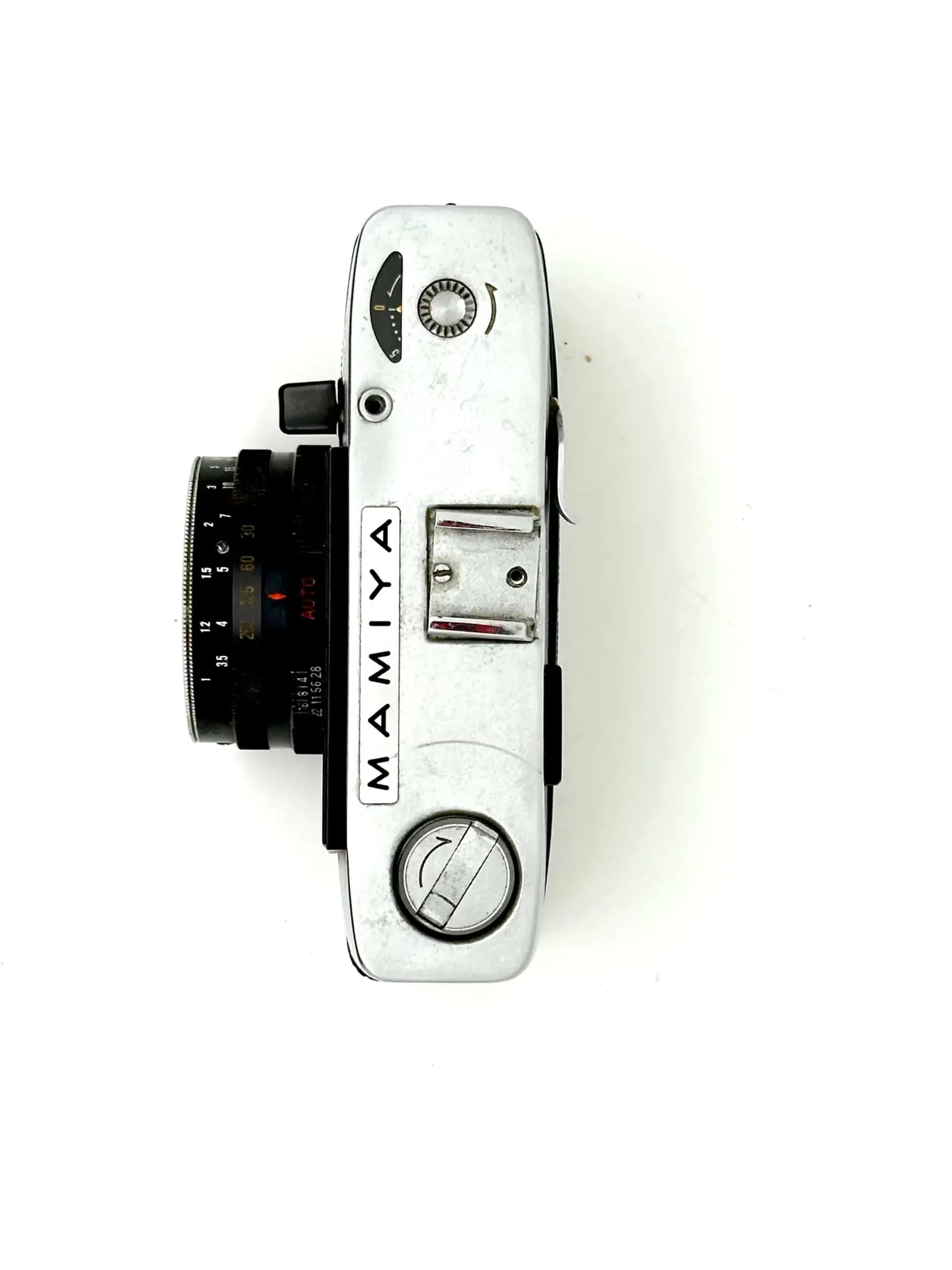 Silver-bodied mamiya film camera with a black lens and classic rangefinder design.