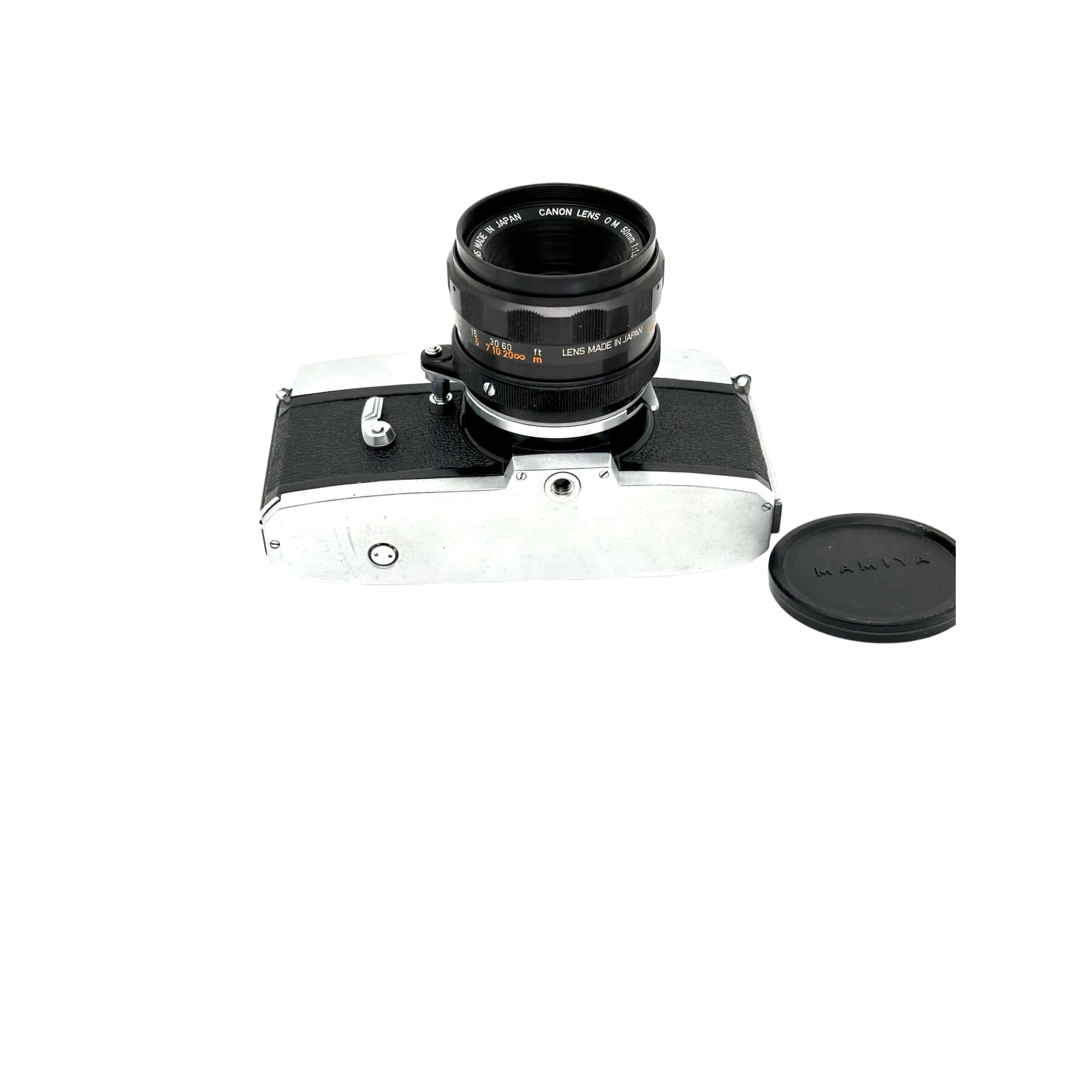 Silver and black canon camera body with a matching lens mounted on top.