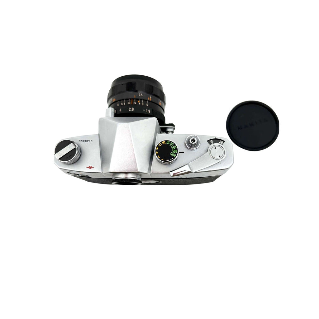 Silver-bodied rangefinder camera with a black lens and matching black shutter speed dial.