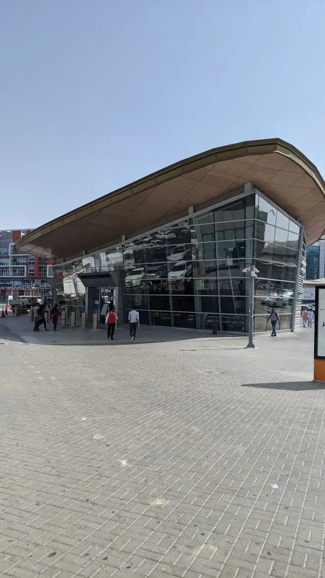 Modern Dubai Metro station with curved glass-steel roof on two routes