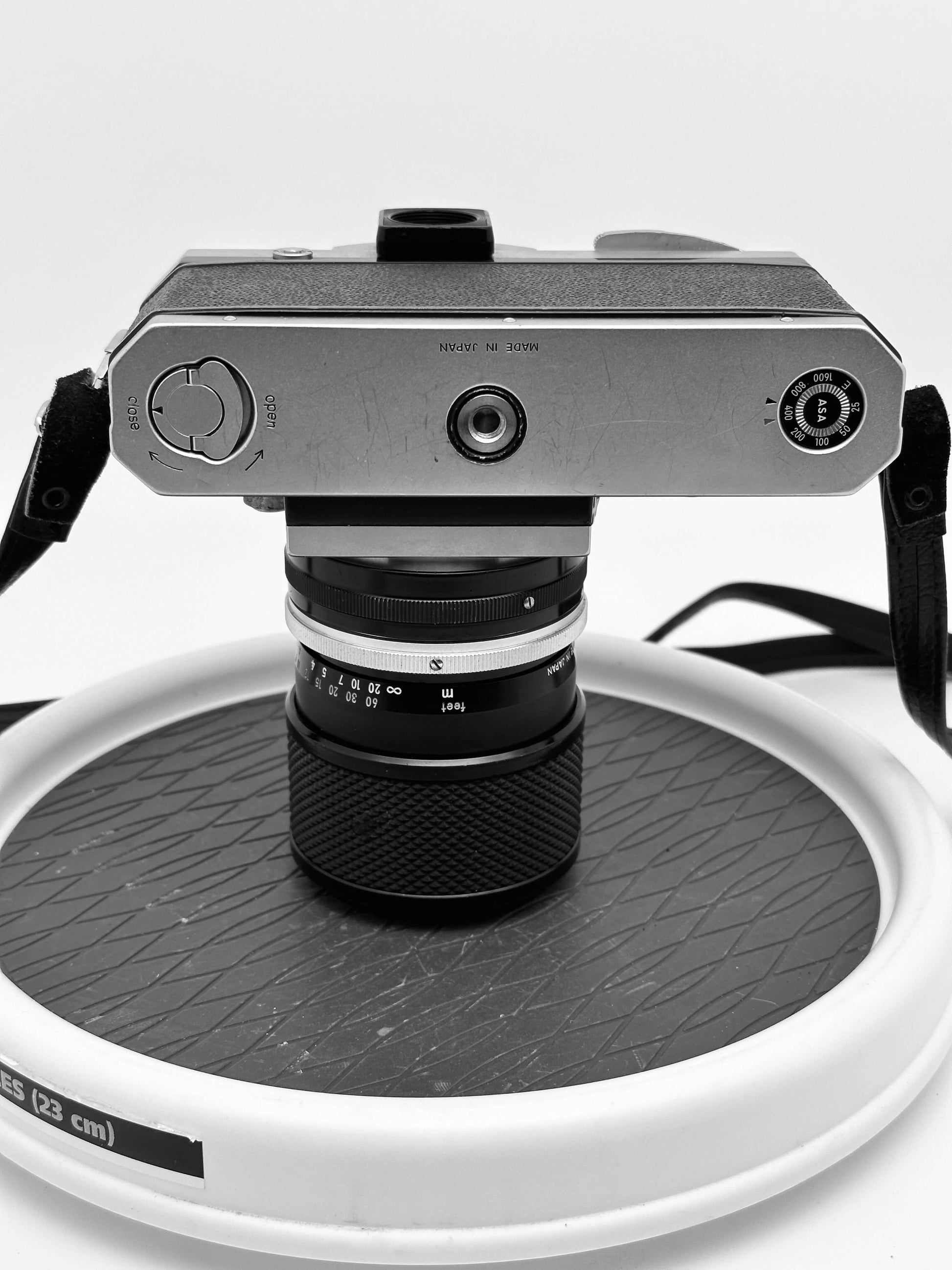 Vintage Nikon F film camera with Nikkor 43-86mm lens, showcasing its classic design and analog photography appeal.