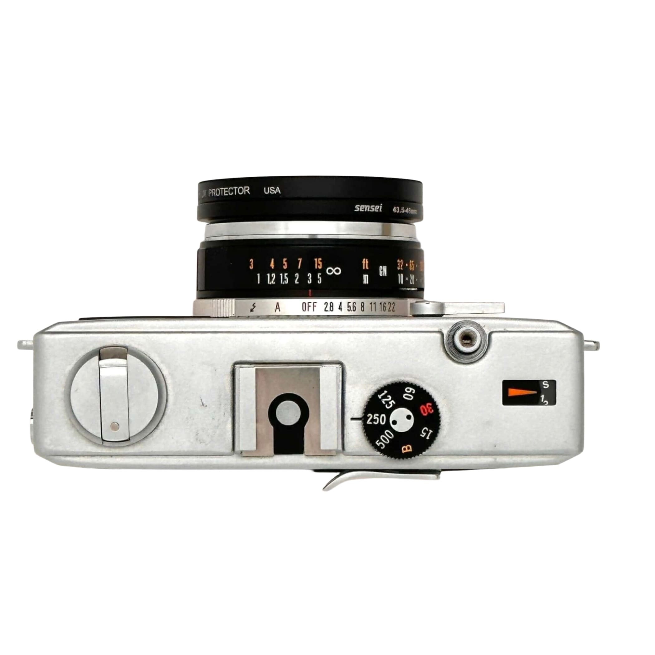 Silver-bodied rangefinder camera with a black and silver lens marked ’sensei 43-5.6mm’ mounted on top, featuring manual focus dials and shutter speed settings visible on its side panel.