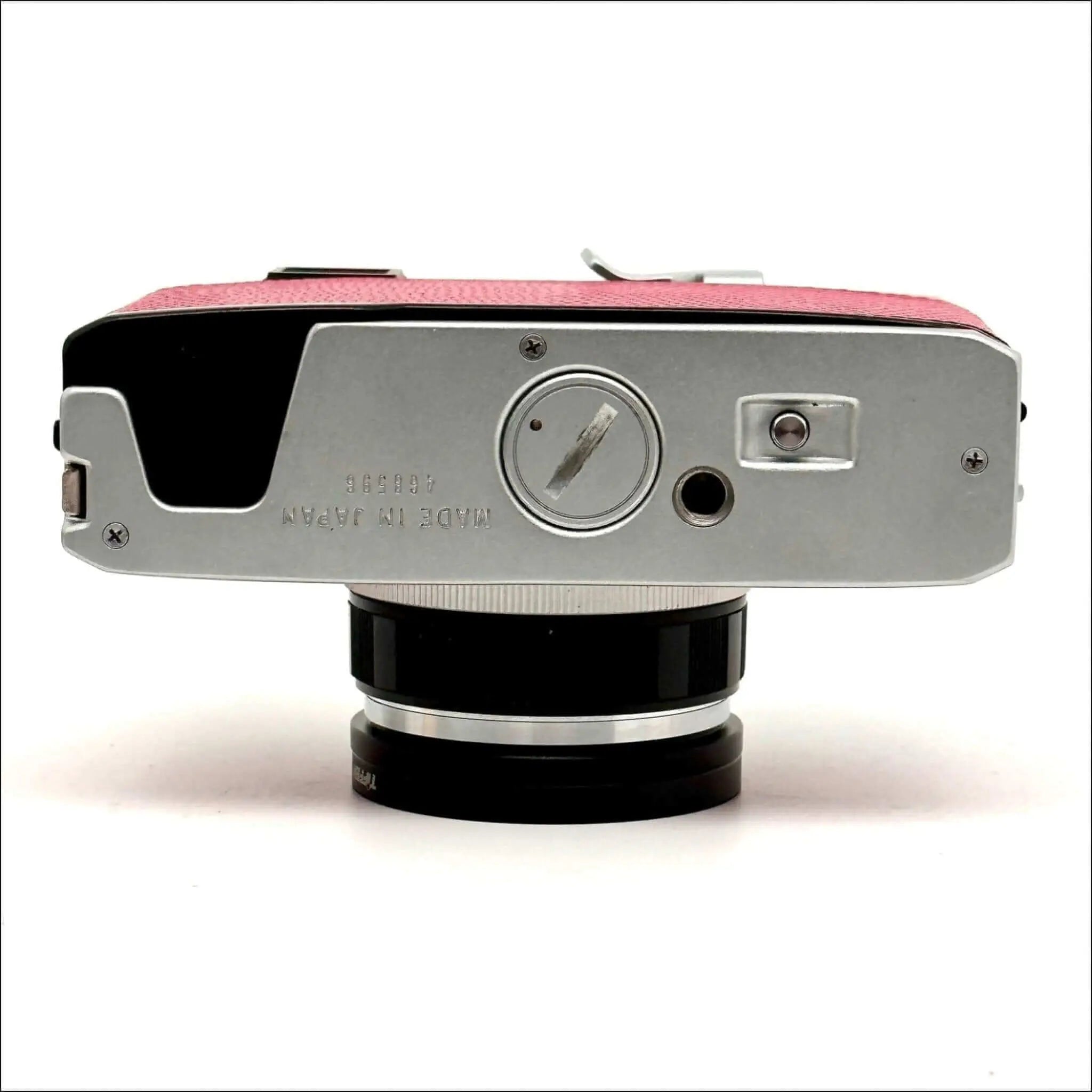 Pink textured leather top with silver metal body and black lens mount, featuring a vintage camera design.