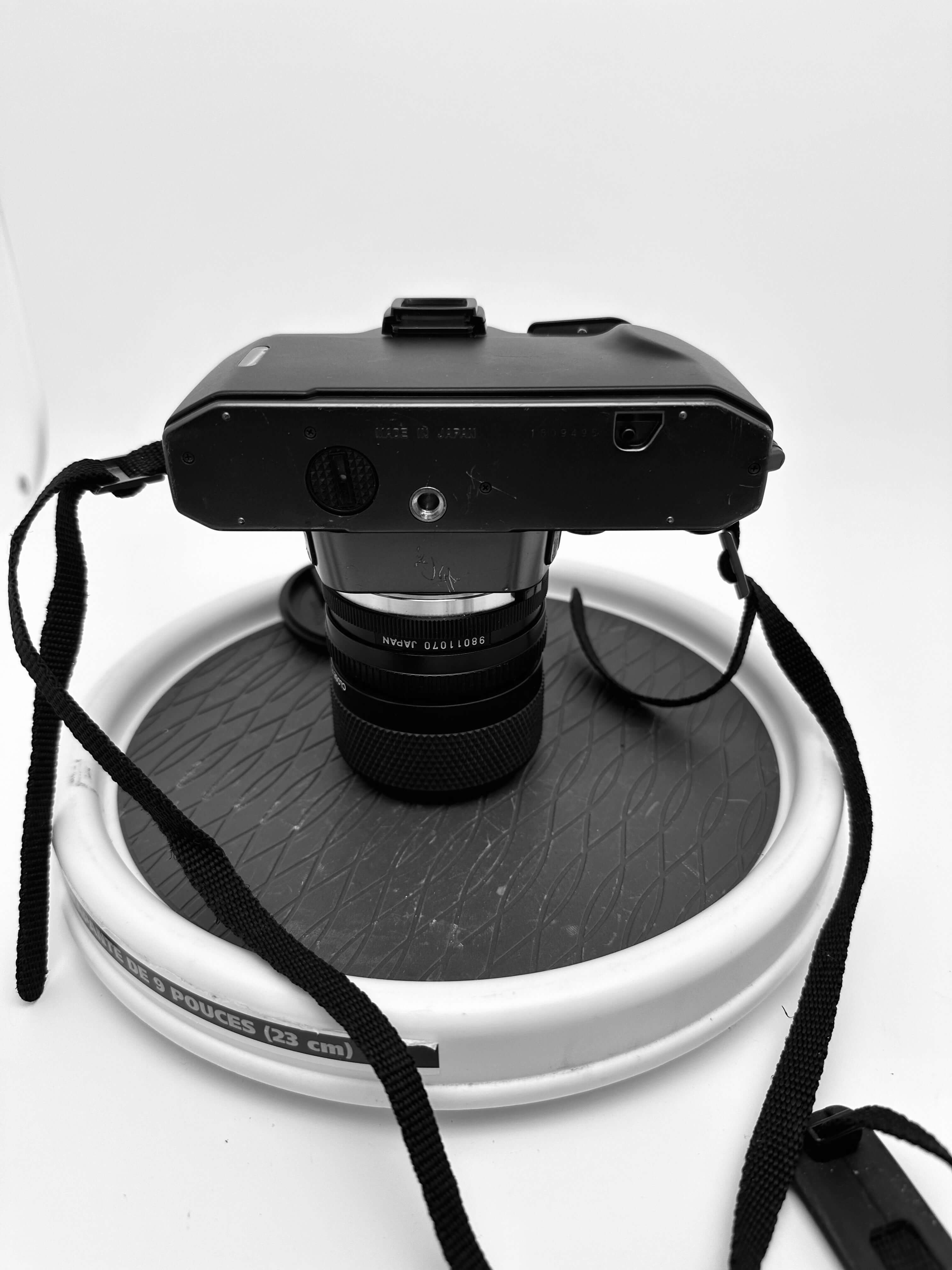 Top view of an Olympus OM 2000 film camera with 35-70mm lens, showcasing a vintage analog design.