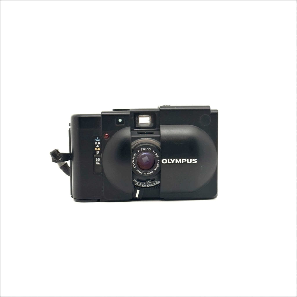 Black olympus xa-1 instant camera with a rounded lens and film counter.