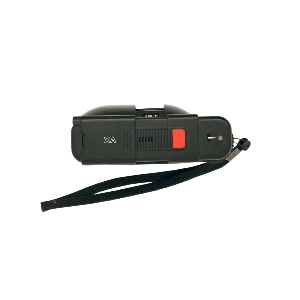 Black plastic stun gun with a red trigger and a black wrist strap.