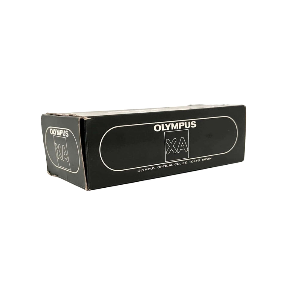 Black rectangular box with white ’olympus xa’ branding and text indicating olympus optical co.
