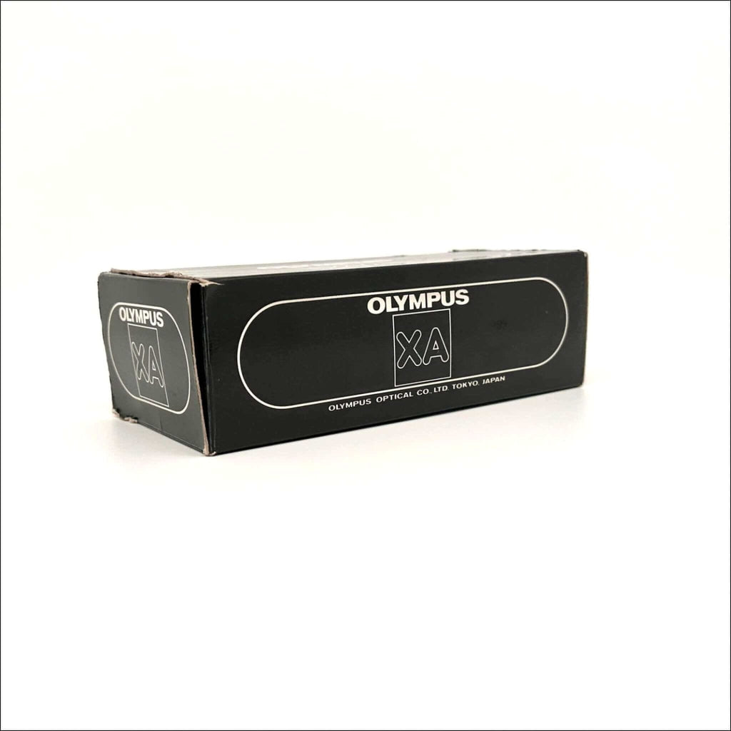 Black rectangular box with white ’olympus xa’ branding and text indicating olympus optical co.