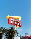 A vibrant red and yellow in-n-out burger sign with bold white lettering on optik oldschool opticolour 200 c41 color negative film