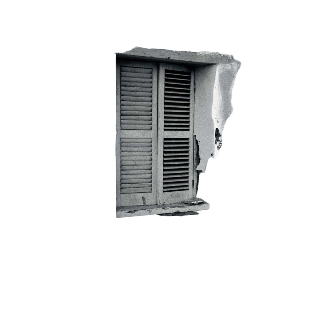 Weathered wooden shutters with horizontal slats frame a window set into a textured, peeling white stucco wall.