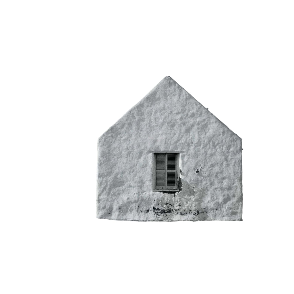 A white stucco house with a triangular roof and a single window featuring wooden shutters.