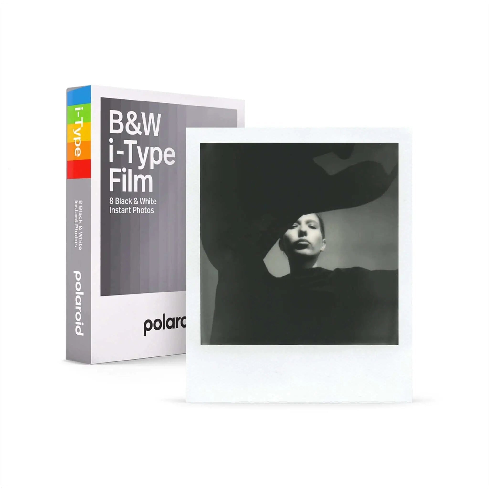 White polaroid i-type film box with rainbow-colored spine and a black-and-white instant photo displayed beside it.