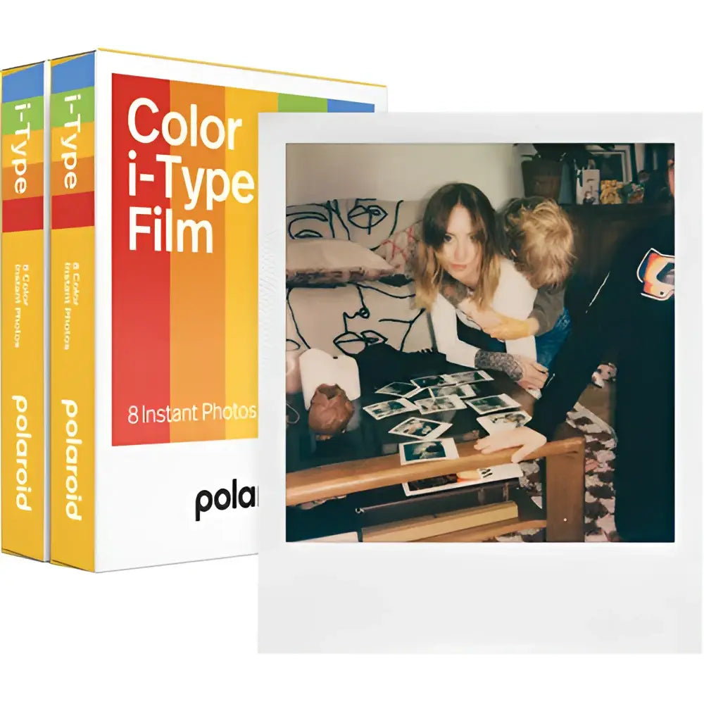Polaroid color i-type film pack with vibrant rainbow-striped packaging and a nostalgic instant photo of two people gathered around printed images.