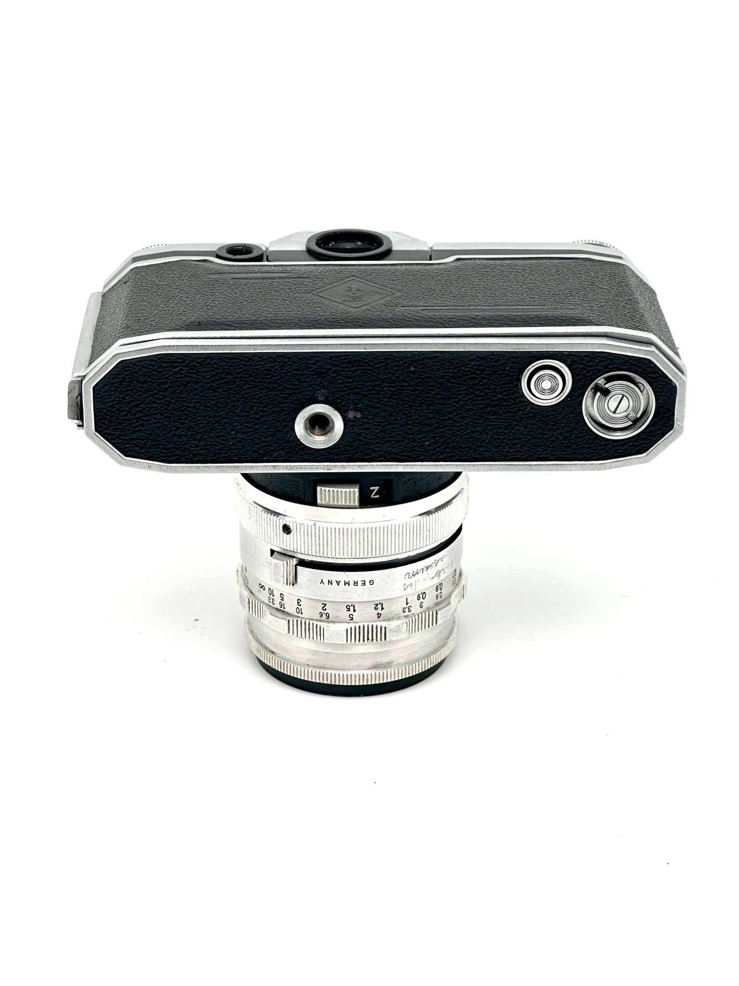 Praktina FX vintage 35mm film camera top view with CZJ Flektogon 35mm f2.8 lens, showing wear and tear.