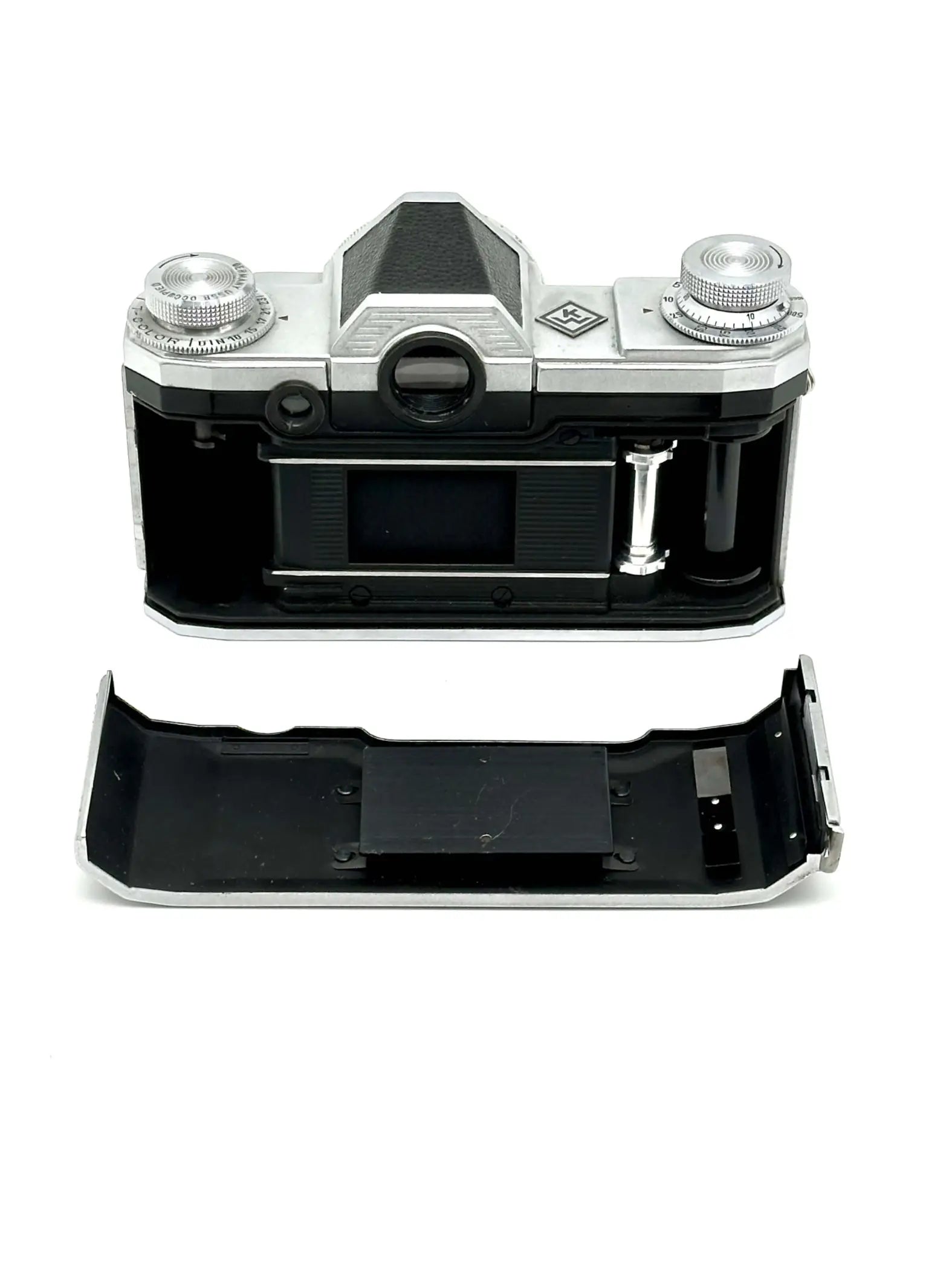 Silver and black kodak retina 35 film camera body with exposed internal components.