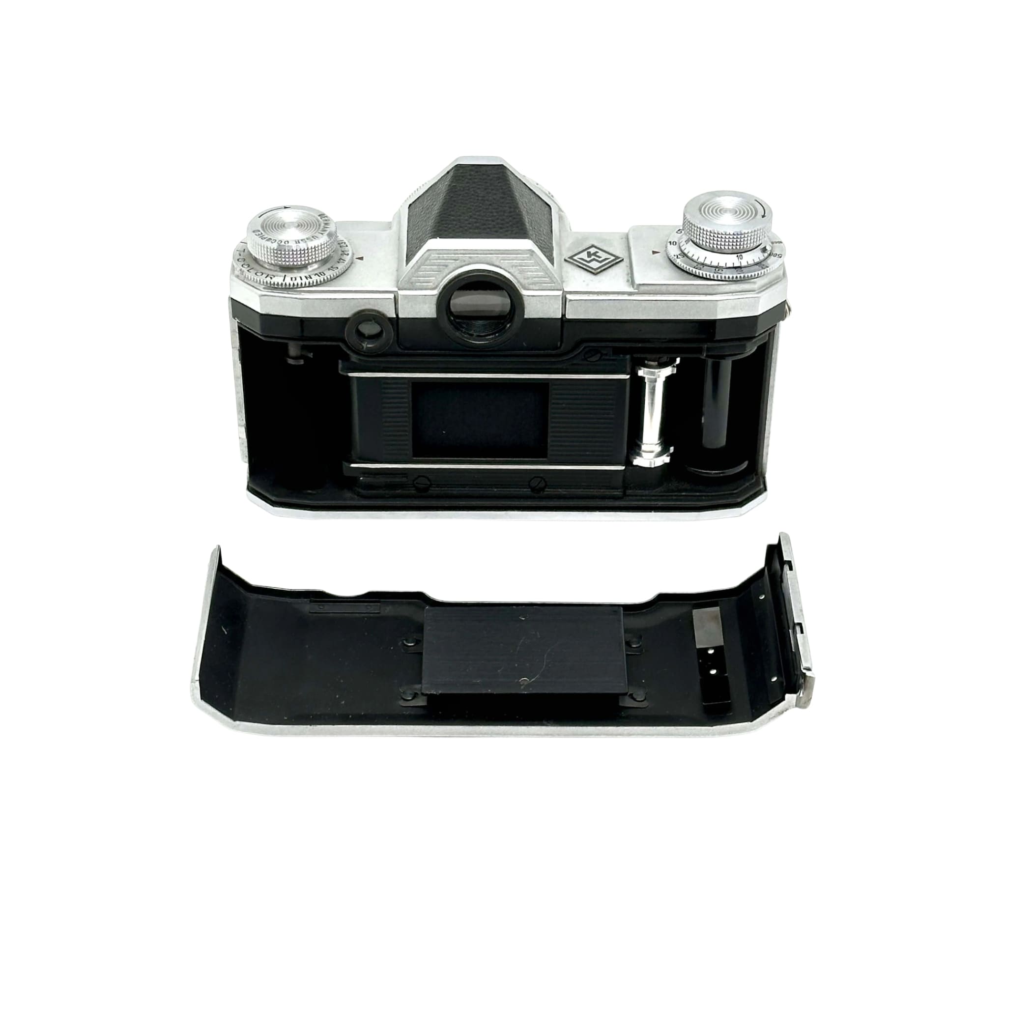 Silver and black kodak retina 35 film camera body with exposed internal components.