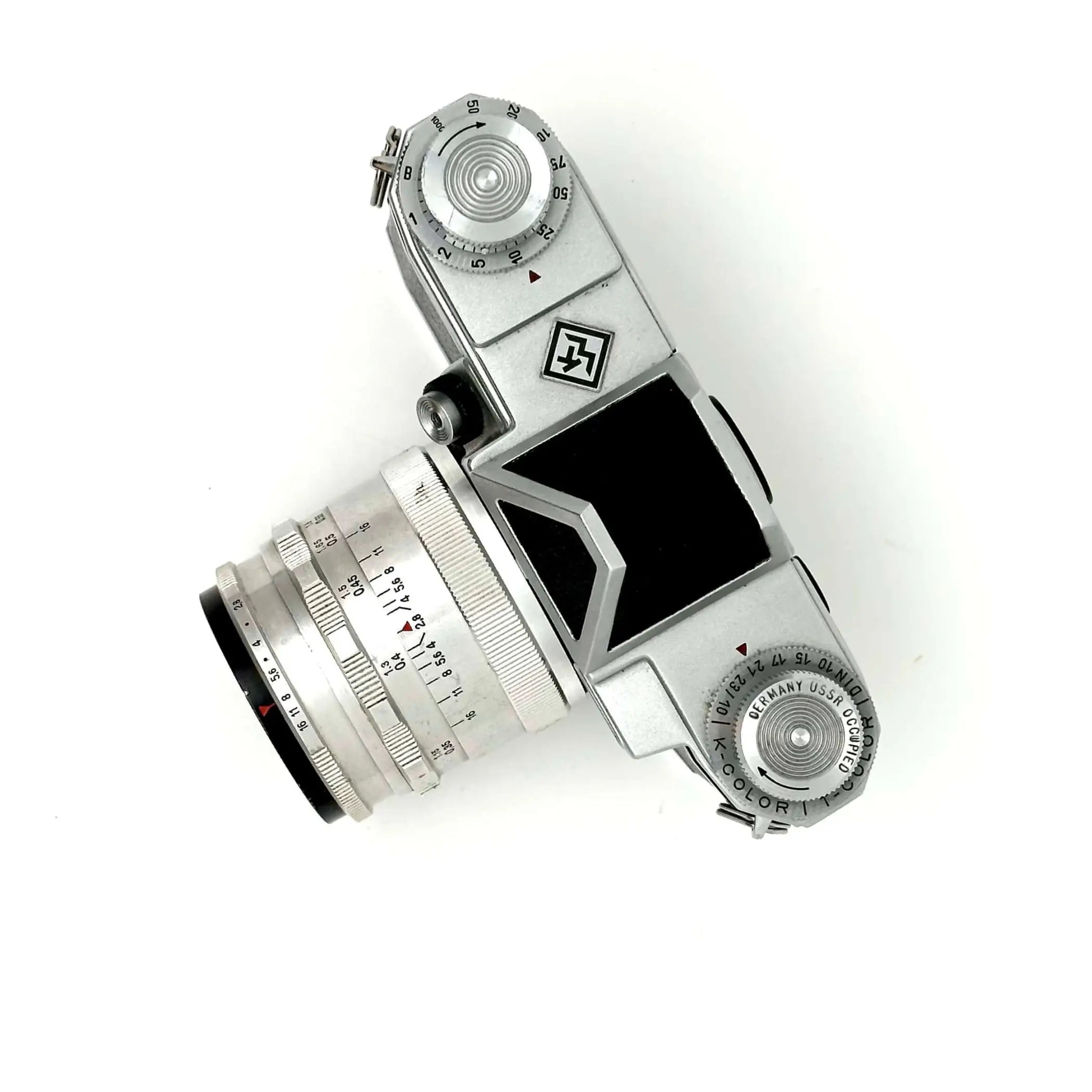 Silver-bodied vintage camera with a matching lens, featuring engraved markings and a black viewfinder window.