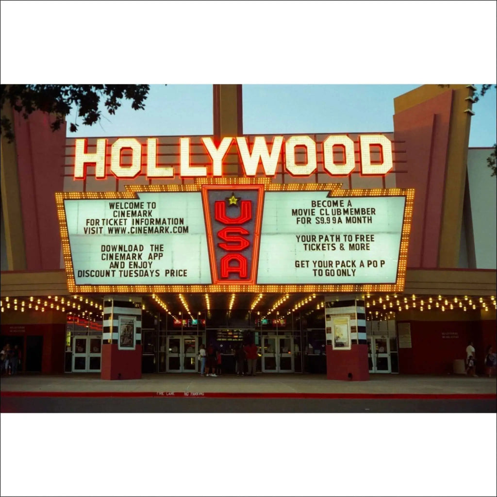 The illuminated ’hollywood’ marquee with red neon lettering and a central usa logo, framed by glowing lights above the cinema entrance.