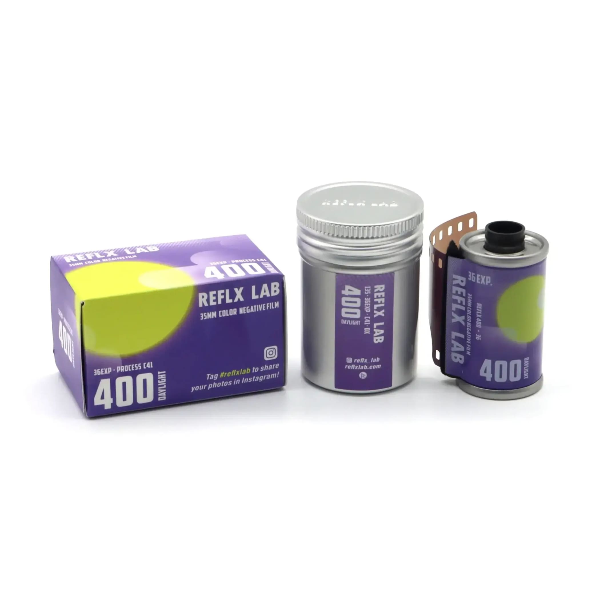 Purple and silver reflex lab 400 daylight 35mm color negative film canister with a partially unspooled roll.