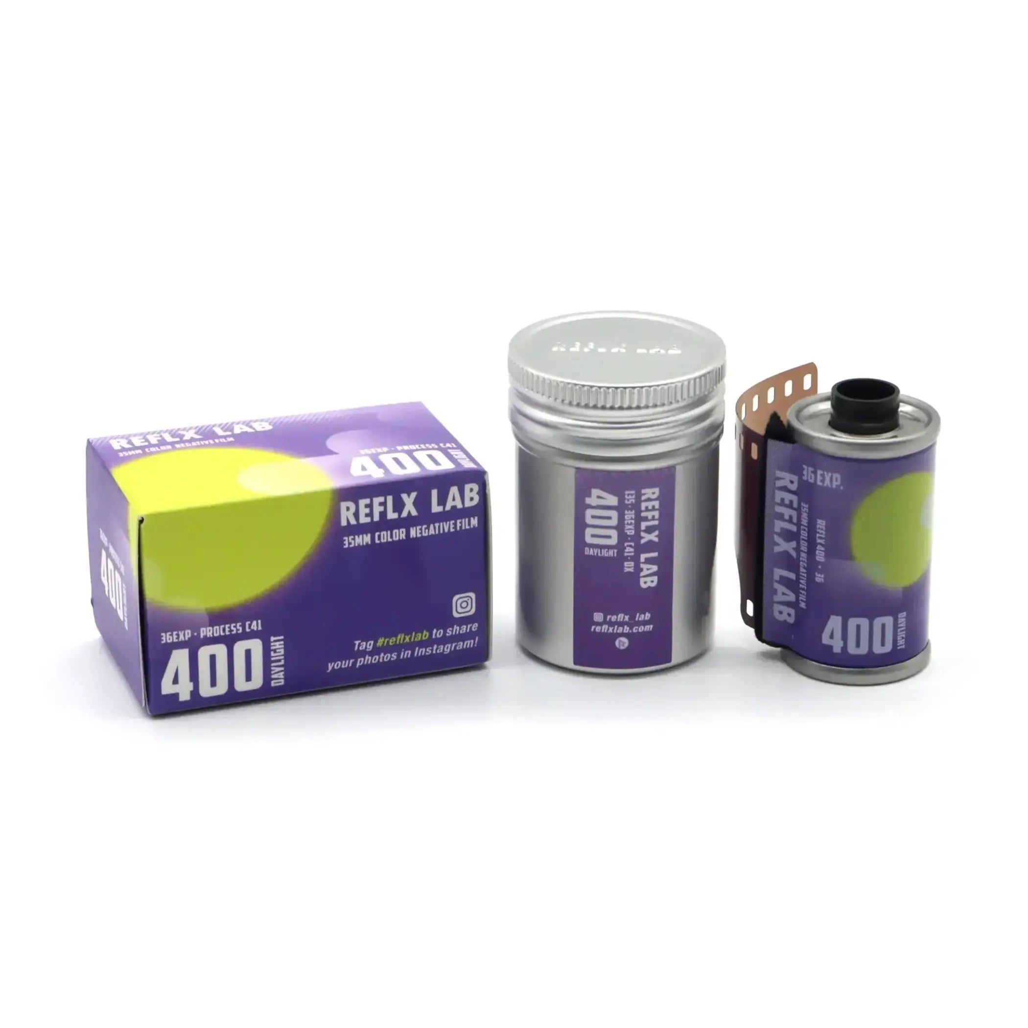 Purple and silver reflex lab 400 daylight 35mm color negative film canister with a partially unspooled roll.