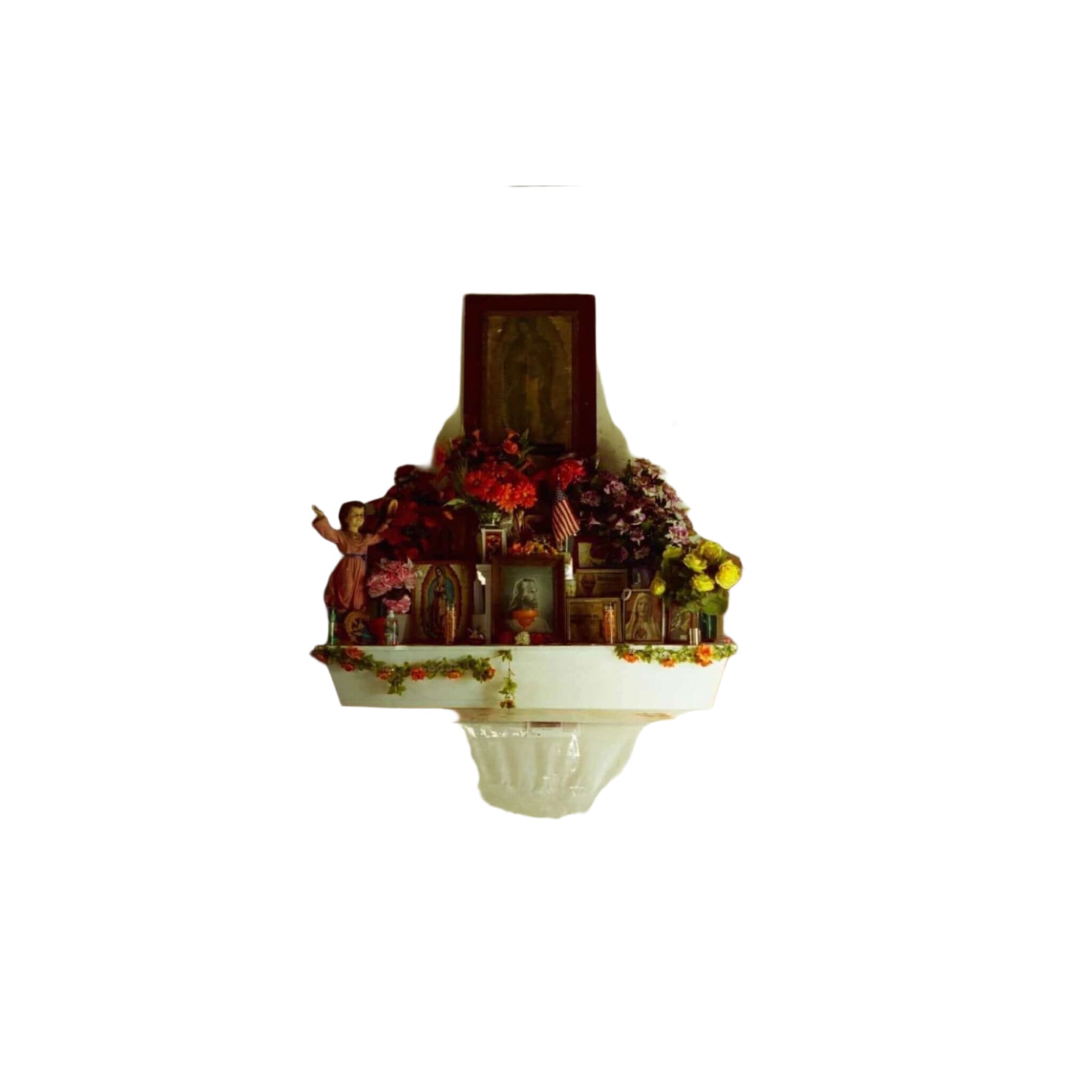 A white altar adorned with vibrant red, pink, and yellow flowers arranged in lush bouquets on either side of a central religious statue.