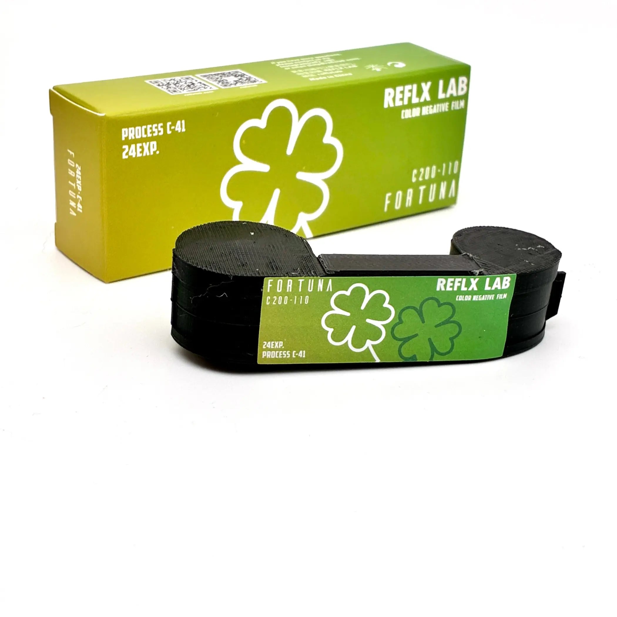 Black cylindrical roll of reflex lab fortuna c200 color negative film with green label and shamrock design