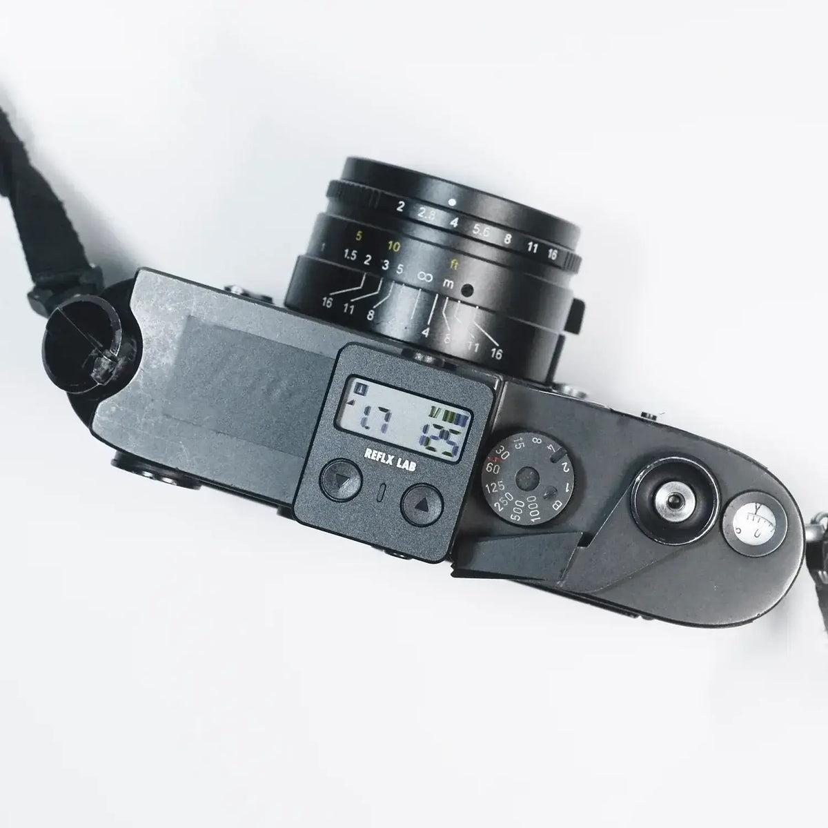 Reflx Lab Digital Light Meter on top of a camera, displaying measurements for accurate exposure settings.