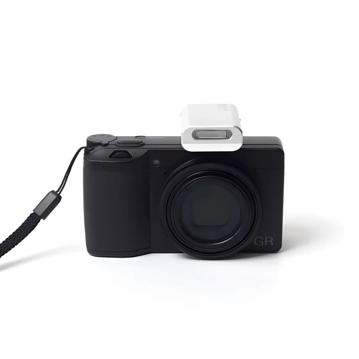 Black compact camera with a white flash attachment and black wrist strap.