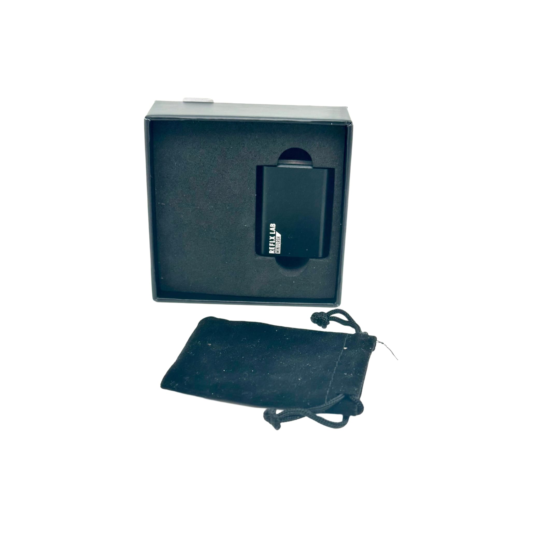 Black rectangular reklab portable charger in sleek matte finish, nestled inside its branded box with a matching velvet pouch.