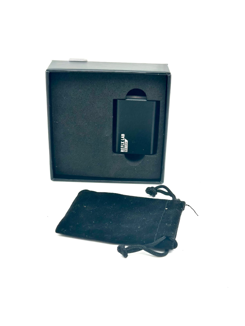 Black rectangular reklab portable charger in sleek matte finish, nestled inside its branded box with a matching velvet pouch.