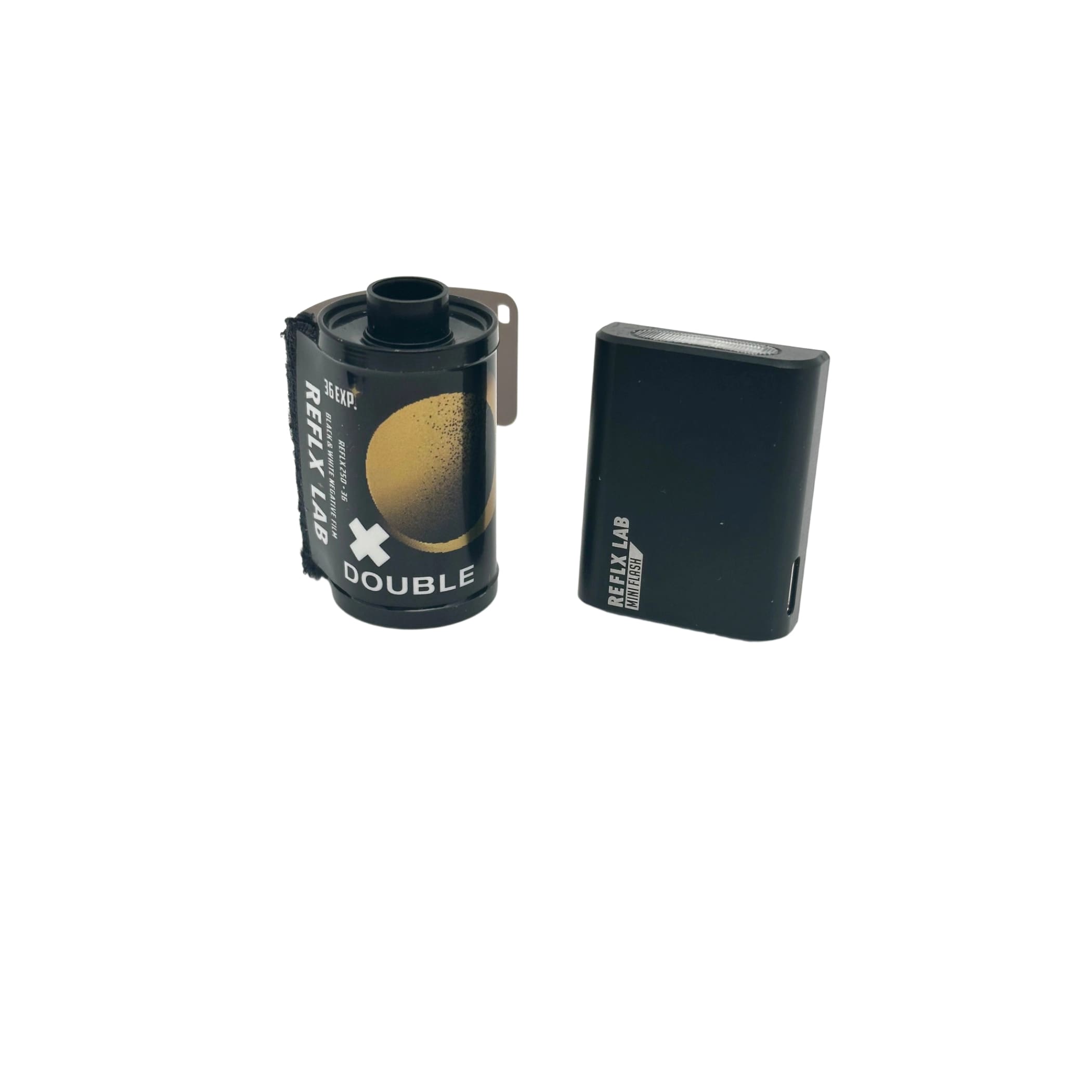 Black reflex lab double film canister with gold circular design and a matching black rectangular battery pack.