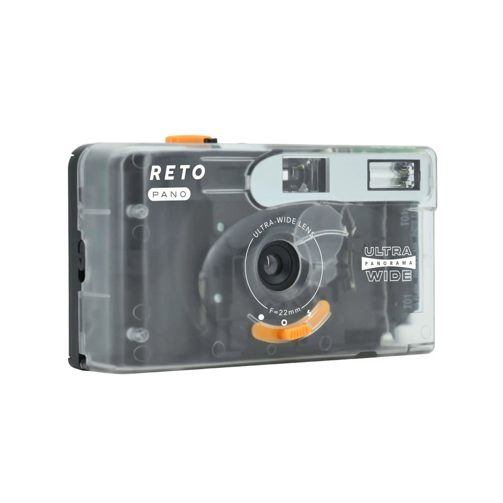 Transparent plastic camera with orange accents and ’reto pano’ branding.