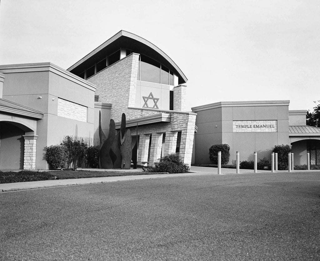 Exterior view of Temple Emanuel featuring modern architecture and a Star of David in black and white.